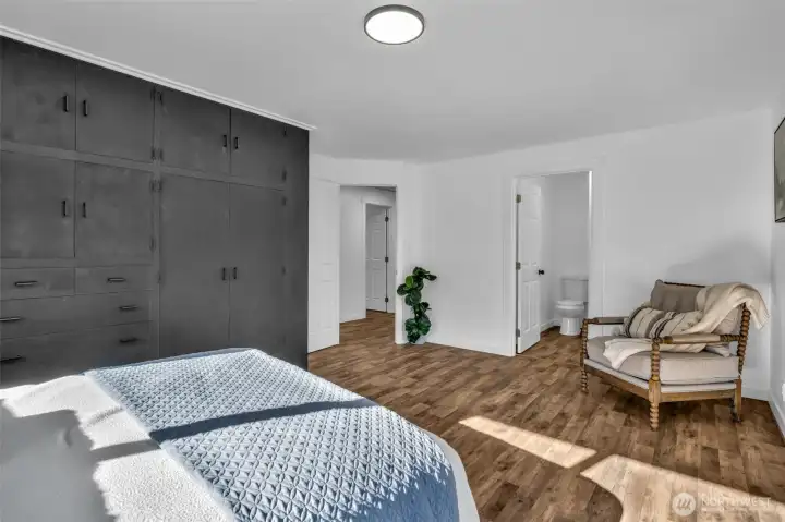 Hallway entrance to the left and the primary bathroom ahead