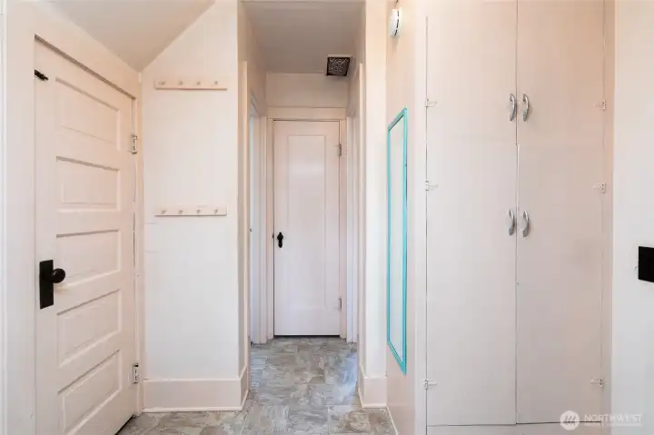 Hallway. Closet straight ahead. Built in storage to right.