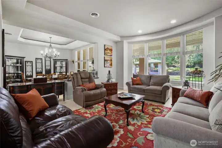 Formal living and dining rooms with accent lighting and coffered ceilings. Floor to ceilings for abundant natural lighting.