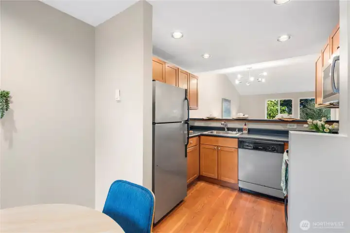 Dining room & kitchen with warm wood laminate hard flooring