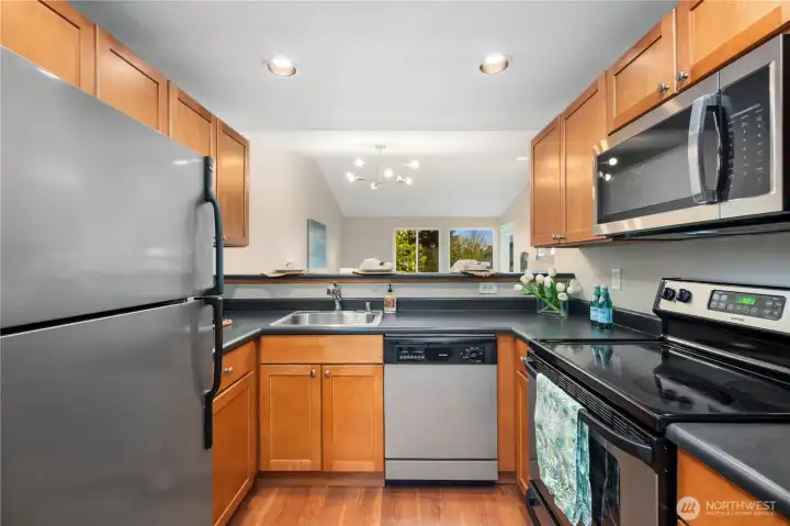 Kitchen with lovely warm wood cabinets & Stainless Steel Appliances