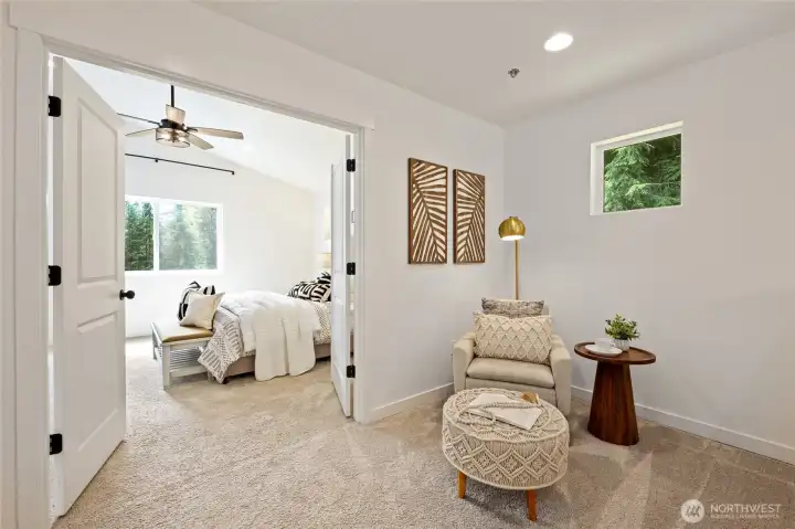 Double door entry to primary bedroom with nook at the top of the stairs.