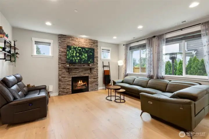 Great room/living area with wall of windows fills the space with natural light.  The gas fireplace keeps you warm and cozy on cold days.