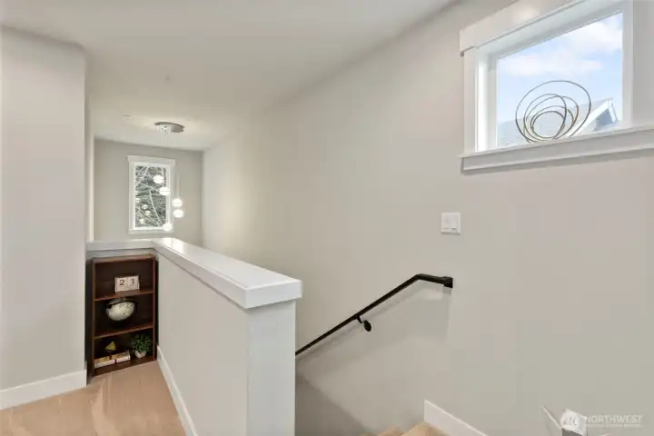 Second floor landing with windows letting in the sunlight.