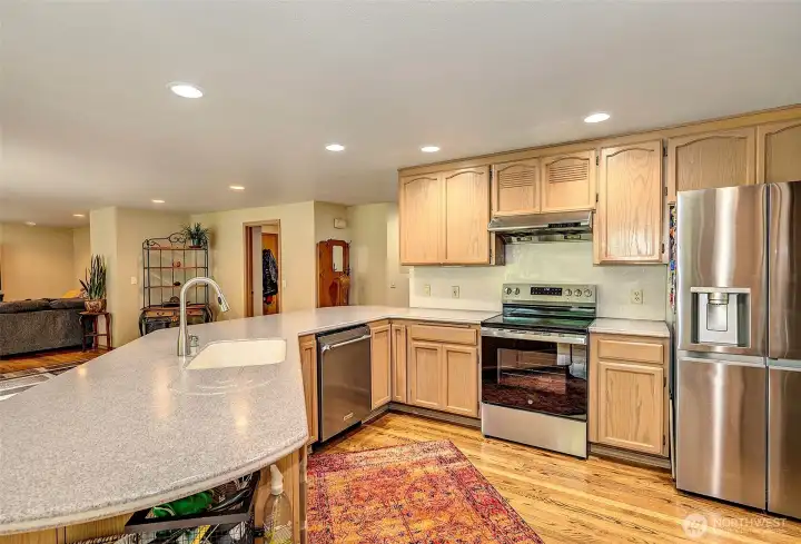 Kitchen with eating space offers a large breakfast bar, plenty of cabinetry and stainless appliances.