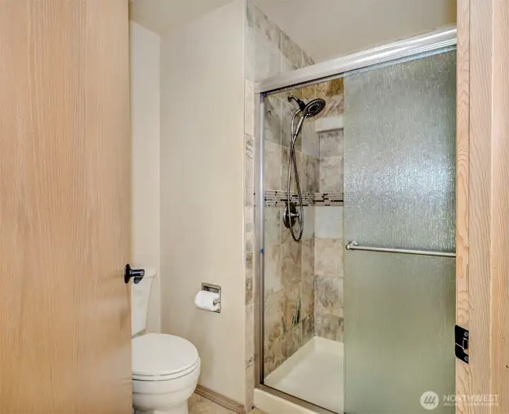 Primary with a walk in tiled shower.