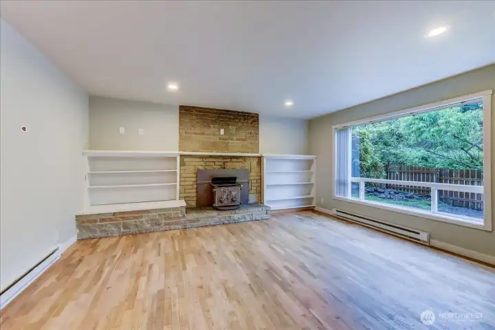 Warm hardwood floors and a cozy fireplace flanked by bookshelves will be a favorite gathering place Warm hardwood floors and a cozy fireplace flanked by bookshelves will be a favorite gathering place