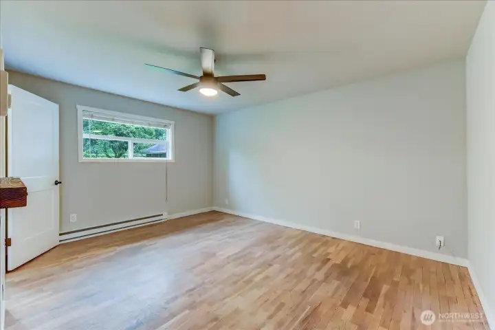 primary bedroom with ceiling fan and electric fireplace primary bedroom with ceiling fan and electric fireplace
