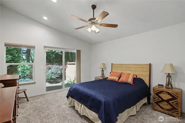 Primary bedroom with sliding glass doors that lead to back patio. Primary bedroom with sliding glass doors that lead to back patio.