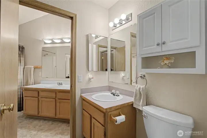 The half bath is just as you start heading to the primary bedroom. There is a door that leads to the Primary bathroom. The half bath is just as you start heading to the primary bedroom. There is a door that leads to the Primary bathroom.