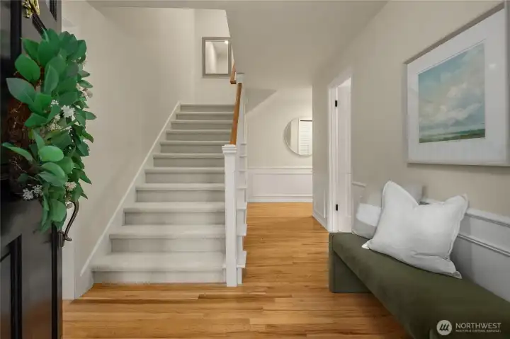 Charming, light-filled entry foyer makes an immediate statement with its rich, refinished hardwood floors, new carpet and tasteful fresh paint.