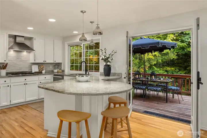 A bright garden window as well as French doors connect the kitchen effortlessly to the outdoor living space making this kitchen as practical as it is charming.