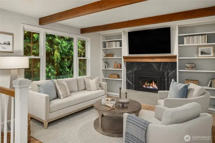 Bonus/family room adjacent to the kitchen- freshly painted with a beautiful large gas fireplace newly reclad in two kinds of porcelain tile. Thoughtfully designed for relaxing, entertaining, game nights, or staying connected to the action in the kitchen.