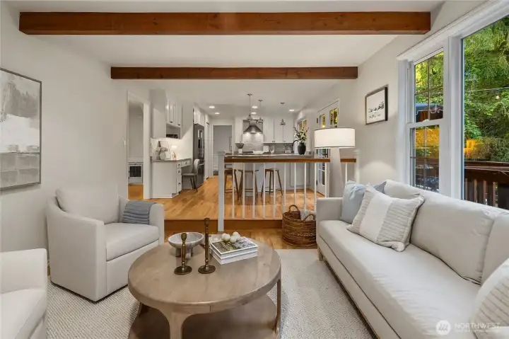 In the bonus/family room adjacent to the kitchen, the large picture window frames a lovely view of the lush greenbelt, filling this thoughtfully designed room with natural light and bringing the outdoors in.