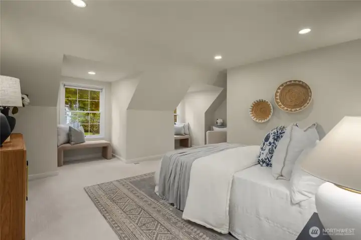 Spacious and charming primary bedroom. Full of natural light and beautiful views from the dormer windows.