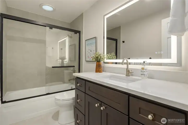 Designed with real life in mind, this generously sized second floor bath turns the morning scramble into something almost civilized — a beautifully practical perk for any bustling household. All new custom cabinetry, polished nickel hardware, LED mirror, Kohler faucet/toilet and Delta bath fittings. New porcelain tile floors and walss. Freshly painted as well.