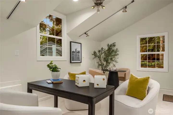 This bright and inspiring executive office off the garage/flex space featuring two charming windows framing views of the newly landscaped yard — a serene backdrop for focused, work-from-home days.