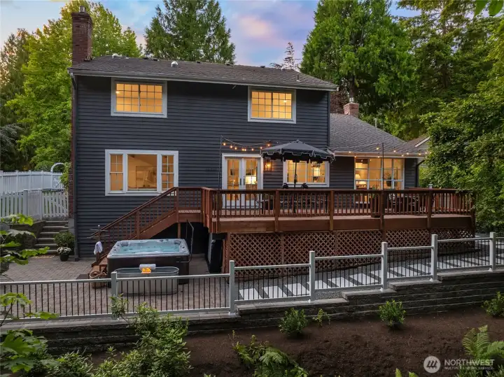 Expansive view of the reimagined backyard - with new retaining wall, beautiful fencing, new native and drought tolerant landscaping, and an impeccably maintained spa retreat - all framed by a serene and private greenbelt. Another example of the home's sanctuary appeal.