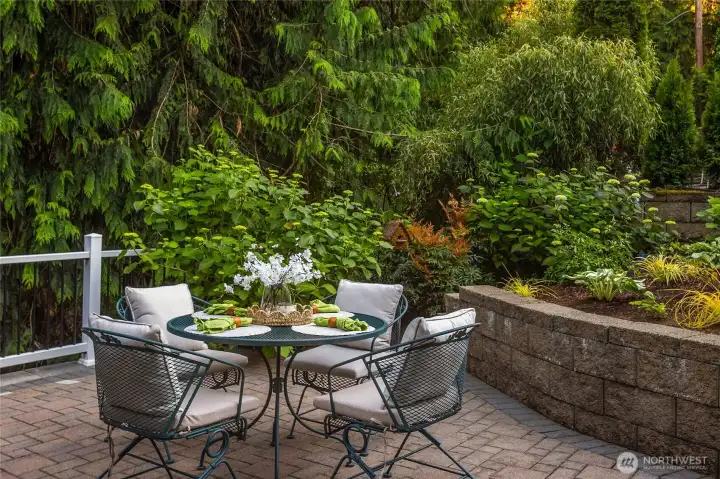 This inviting terraced patio creates a true outdoor living and spa-style retreat, offering ample space for lounge seating, al fresco dining, or relaxed entertaining within the privacy of the partially fenced back yard. Surrounded by lush, mature landscaping and drenched in natural light, it’s an ideal spot to unwind and savor the best of Pacific Northwest living.