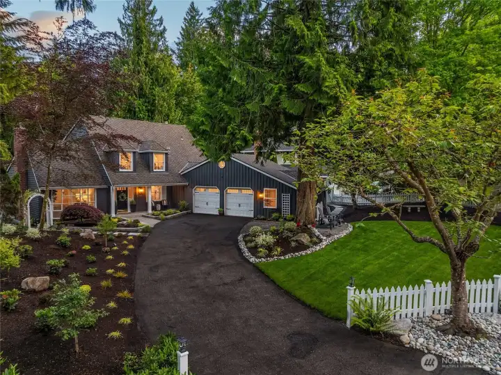 Showcasing signature John Buchan craftsmanship, the home’s inviting exterior is framed by beautifully updated  landscaping, a spacious two-car garage, and a subtly chic, French-inspired parking nook that elevates the everyday arrival.