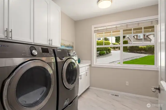 Big bright laundry room with a utility sink.