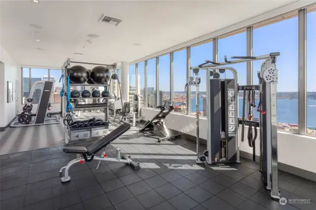 41st floor fitness center inlcludes things often not found in multi-family gyms; Smith machine for squatting and pressing without spots and free weights for bench work.