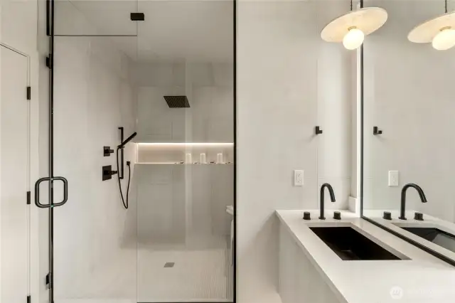 Luxurious Shower Experience: Enjoy the spacious walk-in shower featuring both a rain shower and handheld, complemented by a large illuminated niche for added convenience.