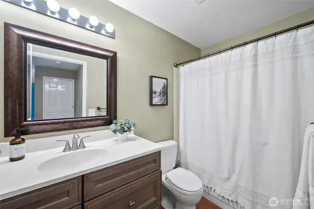bathroom with vanity, tub shower combo
