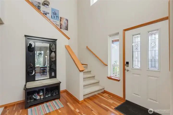 Enter the home to soaring 2-story ceilings and gleaming hardwood floors.