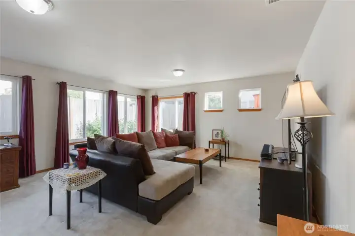 This oversized family room is ideally located adjacent to the kitchen and is large enough to accommodate a large sectional like the one pictured. Ample oversized windows invite in the wonderful natural light.