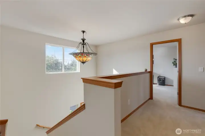 Head upstairs where you will find this nice-sized landing.  There is plenty of space up agains the half wall to put a desk; the perfect study spot!