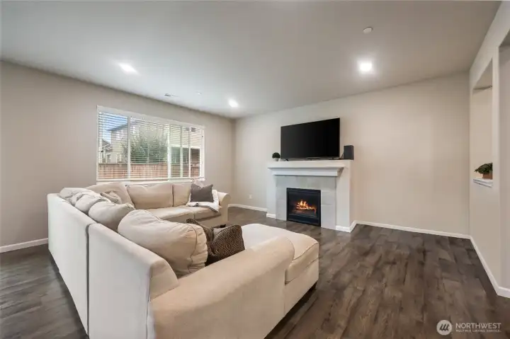 Room for a variety of furniture configurations, with space for bookshelves or reading chairs flanking the stylish gas fireplace.