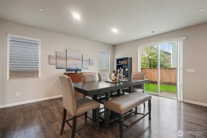 SO MUCH SPACE here... for an expandable dining table, or whatever set-up might suit your specific needs. Natural light shines in through the windows and slider.