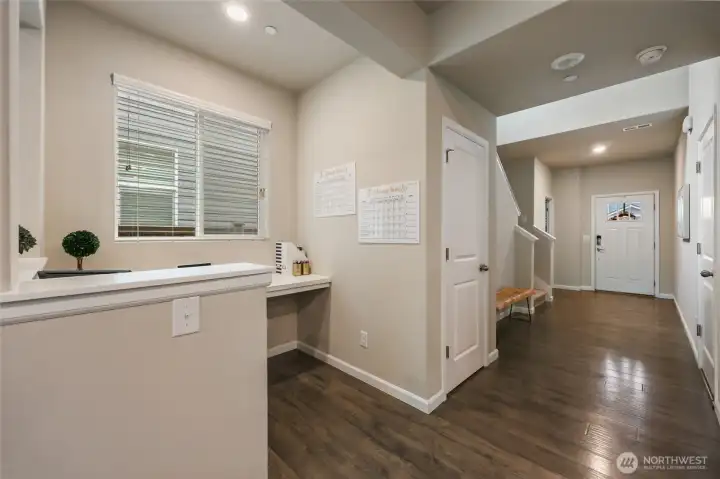 Wide and bright entry hallway leads to coat closet, garage on right, 1/2 bath near the front door, and stairway to second level...