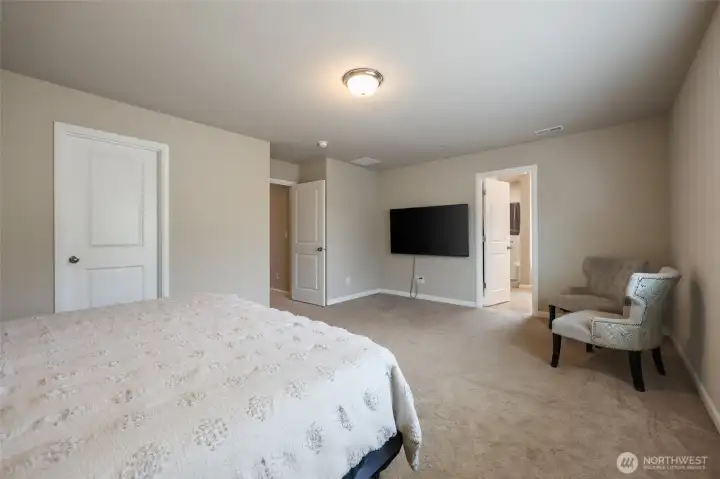 Walk-in-closet on left, and lovely 5-piece bath seen ahead.