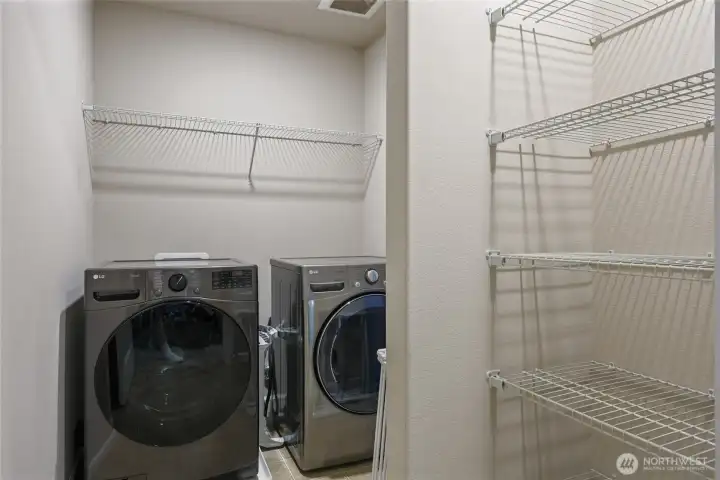 Also upstairs is this convenient laundry room, with valuable storage included!