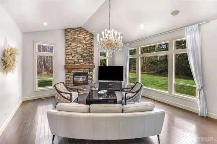 Living room with large picture windows overlooking the yard