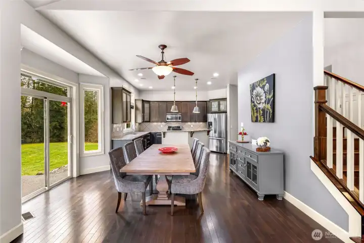 Dining and living areas with large windows and natural light