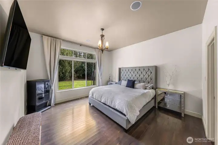 Spacious primary bedroom with large window and natural light