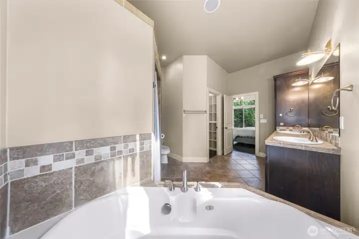 Primary bathroom with soaking tub and tile surround