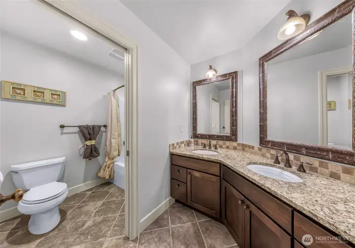 Bathroom with extended vanity and storage with shower/tub in pocket door toilet room