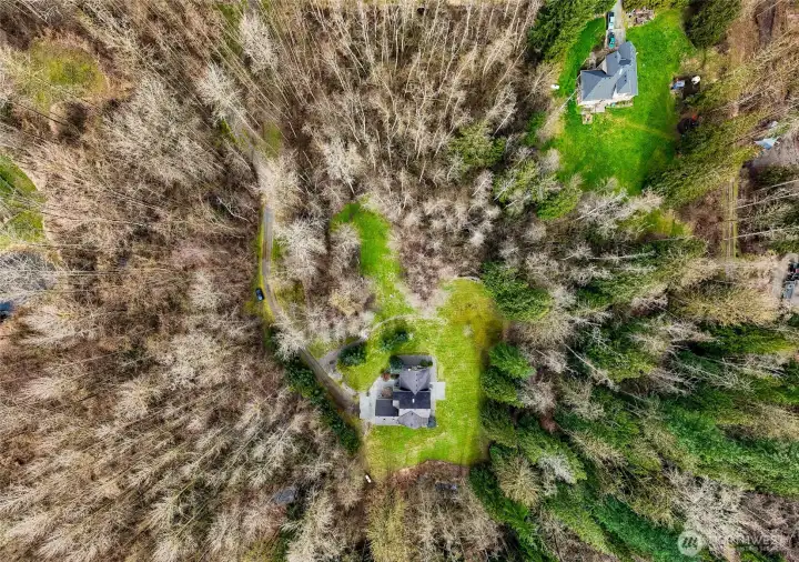 Aerial view showing the property surrounded by trees and privacy