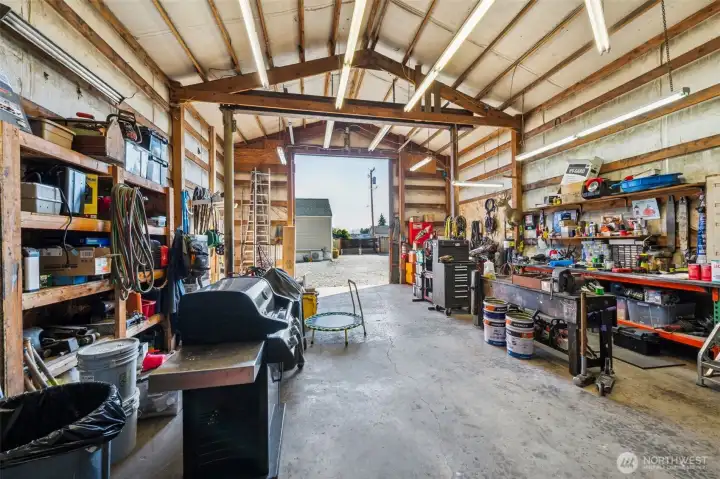 Insulated detached shop- concrete floors, insulated walls, plenty of light & storage racks.
