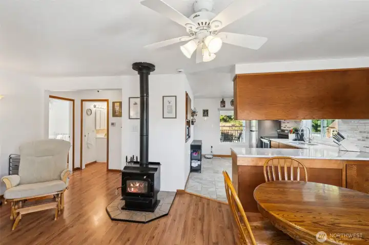 Steps inside the front door you are greeted by the warm & cozy woodburning fireplace which opens up the kitchen, dining & family room.