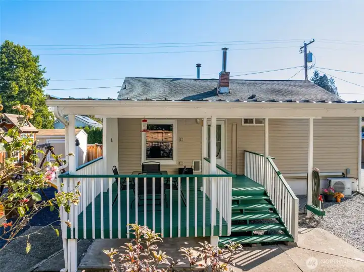 Nicely shaded back deck is the perfect spot for an afternoon beverage watching little ones on the playground. NEWLY replace air conditioner too!