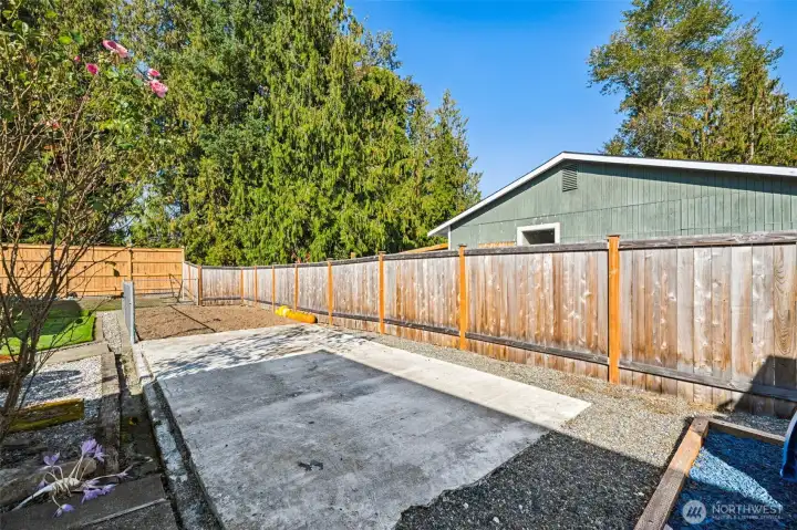 Cement pad between the garden area & playground- four square?