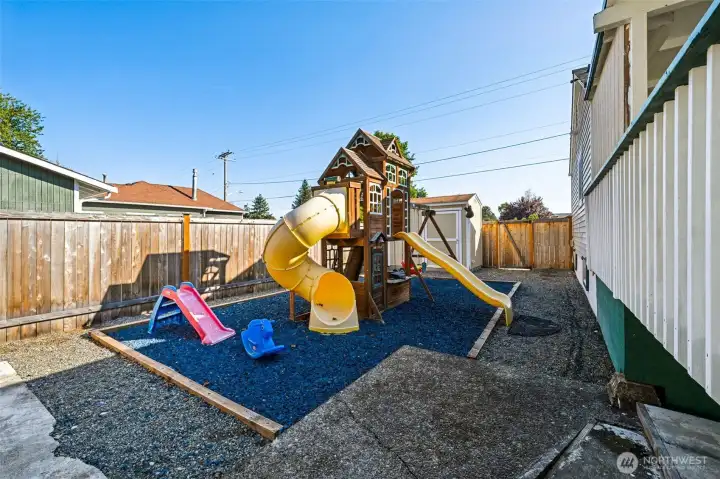 Playground area on side of the house with rubber chips to make playing easy on the kids.