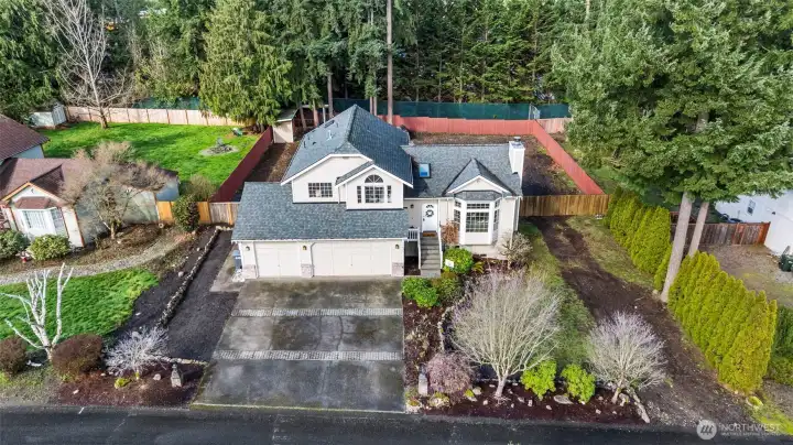 Front of house with 3-car garage, additional parking for RV/boat