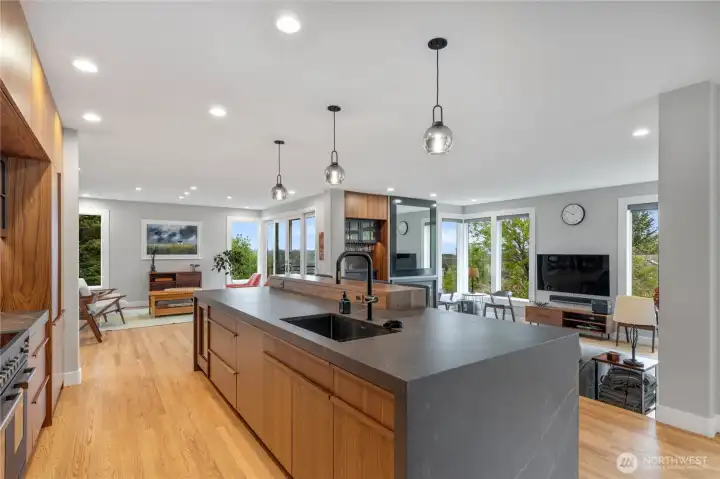 The stunningly renovated kitchen has Dekton countertops, floor to ceiling storage, and a 48" Bertazzoni professional series range with double ovens and an induction cooktop. This space is ideal for entertaining and has an easly flow. Wrapped in windows that take in the ciy and mountain views, you feel like you are in an elegant treehouse.