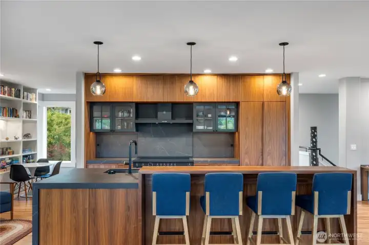 Flanking the range, there is stealthy storage for spices and appliances. You will also find cabinets under the high counter area.